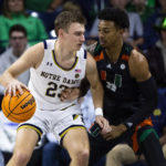 
              Notre Dame's Dane Goodwin (23) works against Miami's Jordan Miller (11) during the first half of an NCAA college basketball game Friday, Dec. 30, 2022 in South Bend, Ind. (AP Photo/Michael Caterina)
            