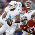 
              Miami Dolphins quarterback Tua Tagovailoa (1) looks to pass before San Francisco 49ers defensive end Nick Bosa (97) caused Tagovailoa to fumble, which 49ers linebacker Dre Greenlaw returned for a touchdown, during the second half of an NFL football game in Santa Clara, Calif., Sunday, Dec. 4, 2022. (AP Photo/Jed Jacobsohn)
            