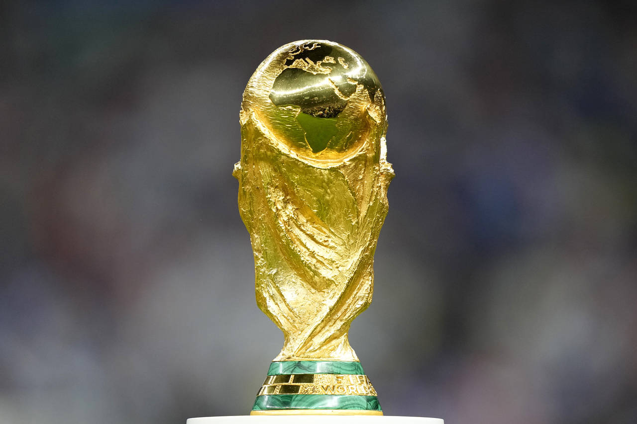 The trophy is displayed on the pitch ahead of the World Cup final soccer match between Argentina an...