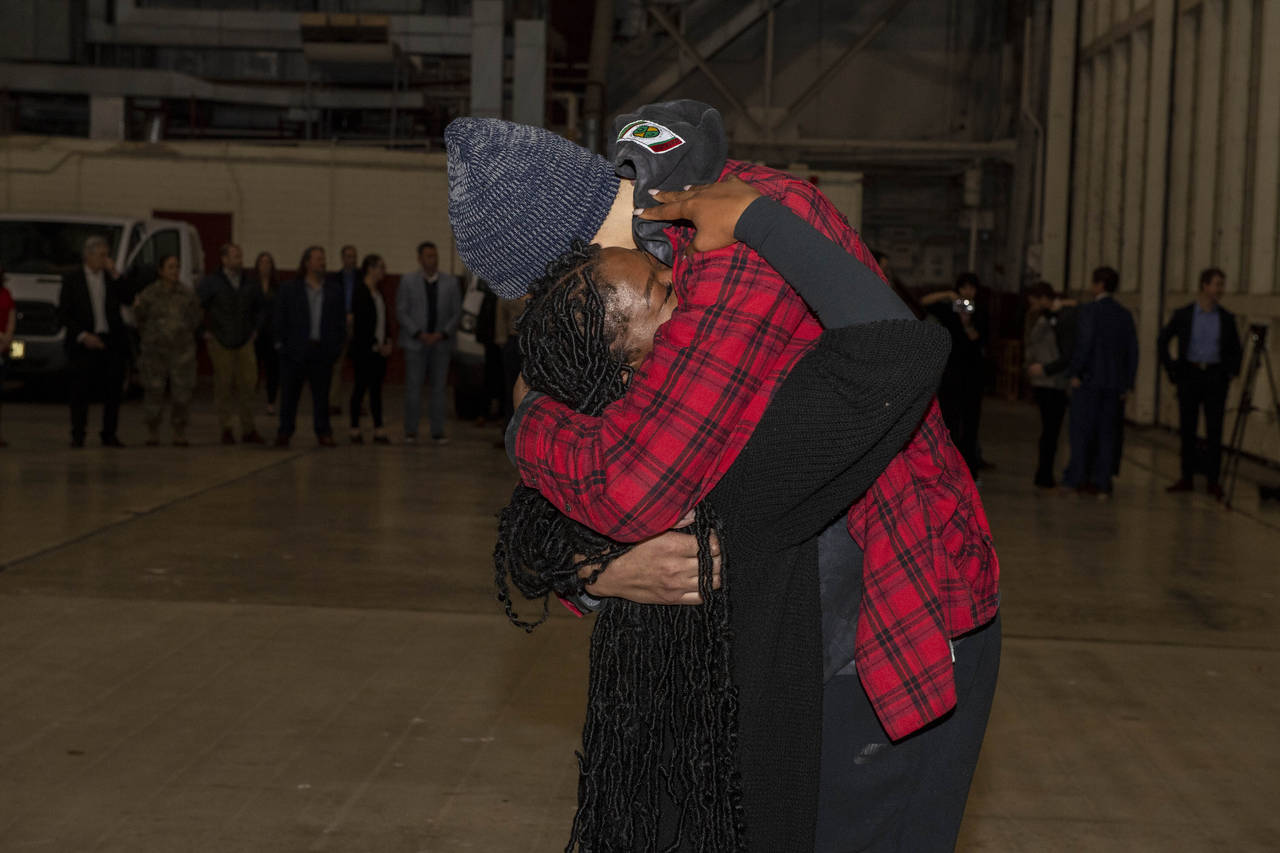 This photo provided by the U.S. Army shows WNBA star Brittney Griner, right, being greeted by wife ...