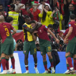 
              Portugal's Goncalo Ramos (26), celebrates with teammates after scoring the opening goal during the World Cup round of 16 soccer match between Portugal and Switzerland, at the Lusail Stadium in Lusail, Qatar, Tuesday, Dec. 6, 2022. (AP Photo/Manu Fernandez)
            