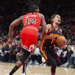 
              Atlanta Hawks guard Trae Young is fouled by Chicago Bulls guard Ayo Dosunmu during the second half of an NBA basketball game, Wednesday, Dec. 21, 2022, in Atlanta. (AP Photo/Hakim Wright Sr.)
            