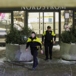 
              Two officers walk out of Nordstrom in Mall of America in Bloomington, Minn., after a shooting on Friday, Dec. 23, 2022. (Kerem Yücel/Minnesota Public Radio via AP)
            