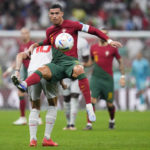 
              Portugal's Cristiano Ronaldo, front, and Switzerland's Granit Xhaka battle for the ball during the World Cup round of 16 soccer match between Portugal and Switzerland, at the Lusail Stadium in Lusail, Qatar, Tuesday, Dec. 6, 2022. (AP Photo/Manu Fernandez)
            