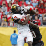 
              Maryland wide receiver Dontay Demus Jr., left, makes a catch against North Carolina State safety Sean Brown during the first half of the Duke's Mayo Bowl NCAA college football game in Charlotte, N.C., Friday, Dec. 30, 2022. (AP Photo/Nell Redmond)
            