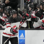 
              Canada forward Laura Stacey, center, celebrates with teammates after scoring during the second period of a Rivalry Series hockey game against the United States Monday, Dec. 19, 2022, in Los Angeles. (AP Photo/Ashley Landis)
            