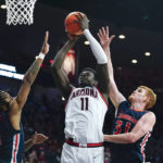 
              Arizona's Oumar Ballo (11) goes up to shoot against Morgan State's Khalil Turner (1) and Ty Horner (31) during the second half of an NCAA college basketball game, Thursday, Dec. 22, 2022, in Tucson, Ariz. (AP Photo/Darryl Webb)
            