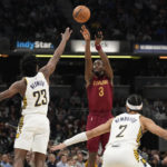 
              Cleveland Cavaliers guard Caris LeVert (3) shoots over Indiana Pacers forward Aaron Nesmith (23) during the first half of an NBA basketball game in Indianapolis, Thursday, Dec. 29, 2022. (AP Photo/AJ Mast)
            