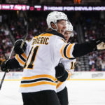 
              Boston Bruins' Trent Frederic (11) celebrates with teammate Pavel Zacha (18) during the second period of an NHL hockey game against the New Jersey Devils Wednesday, Dec. 28, 2022, in Newark, N.J. (AP Photo/Frank Franklin II)
            