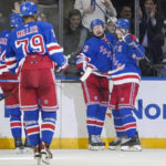 
              New York Rangers left wing Alexis Lafrenière (13) celebrates after scoring in the third period of an NHL hockey game against the St. Louis Blues, Monday, Dec. 5, 2022, in New York. (AP Photo/John Minchillo)
            