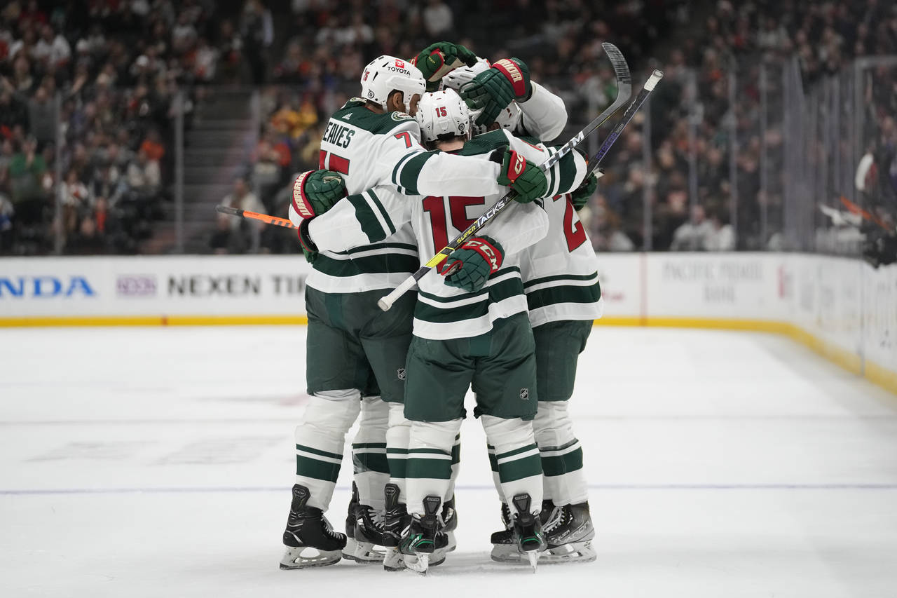 Minnesota Wild players celebrate after center Connor Dewar (26) scored during the second period of ...