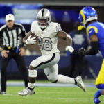 
              Las Vegas Raiders running back Josh Jacobs runs with the ball during the first half of an NFL football game against the Los Angeles Rams, Thursday, Dec. 8, 2022, in Inglewood, Calif. (AP Photo/Marcio Jose Sanchez)
            