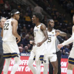 
              West Virginia players celebrate during the first half of an NCAA college basketball game against Buffalo in Morgantown, W.Va., Sunday, Dec. 18, 2022. (AP Photo/Kathleen Batten)
            