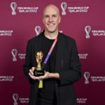 
              Grant Wahl smiles as he holds a World Cup replica trophy during an award ceremony in Doha, Qatar on Nov. 29, 2022. Wahl, one of the most well-known soccer writers in the United States, died early Saturday Dec. 10, 2022 while covering the World Cup match between Argentina and the Netherlands. (Brendan Moran, FIFA via AP)
            