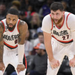 
              Portland Trail Blazers' Damian Lillard (0) and Jusuf Nurkic talk on the court during the first half of an NBA basketball game against the San Antonio Spurs, Wednesday, Dec. 14, 2022, in San Antonio. (AP Photo/Darren Abate)
            