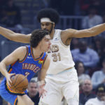 
              Oklahoma City Thunder guard Josh Giddey (3) drives against Cleveland Cavaliers center Jarrett Allen (31) during the first half of an NBA basketball game, Saturday, Dec. 10, 2022, in Cleveland. (AP Photo/Ron Schwane)
            