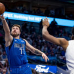 
              Dallas Mavericks guard Luka Doncic (77) shoots a layup while Cleveland Cavaliers center Jarrett Allen (31) attempts to defend in the first half of an NBA basketball game in Dallas, Wednesday, Dec. 14, 2022. (AP Photo/Emil Lippe)
            