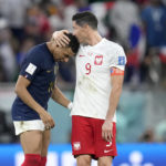 
              France's Kylian Mbappe, left, and Poland's Robert Lewandowski, right, speak after the World Cup round of 16 soccer match between France and Poland, at the Al Thumama Stadium in Doha, Qatar, Sunday, Dec. 4, 2022. (AP Photo/Natacha Pisarenko)
            