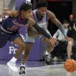 
              Jackson State guard Chase Adams (10) and TCU guard Shahada Wells chase the ball during the first half of an NCAA college basketball game in Fort Worth, Texas, Tuesday, Dec. 6, 2022. (AP Photo/LM Otero)
            