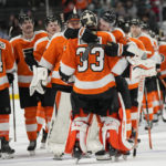 
              Philadelphia Flyers goaltender Samuel Ersson (33) celebrates with teammates after the Flyers defeated the San Jose Sharks in an NHL hockey game in San Jose, Calif., Thursday, Dec. 29, 2022. The Flyers won 4-3 in overtime. (AP Photo/Jeff Chiu)
            