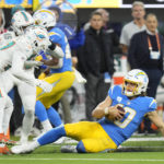 
              Los Angeles Chargers quarterback Justin Herbert slides for a first down during the second half of an NFL football game against the Miami Dolphins Sunday, Dec. 11, 2022, in Inglewood, Calif. (AP Photo/Jae C. Hong)
            
