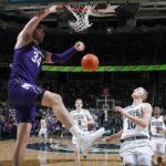 
              Northwestern's Matthew Nicholson, left, dunks against Michigan State's Joey Hauser (10) during the first half of an NCAA college basketball game, Sunday, Dec. 4, 2022, in East Lansing, Mich. (AP Photo/Al Goldis)
            