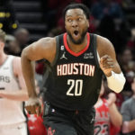 
              Houston Rockets forward Bruno Fernando (20) reacts after dunking during the first half of an NBA basketball game against the San Antonio Spurs, Monday, Dec. 19, 2022, in Houston. (AP Photo/Eric Christian Smith)
            