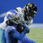 
              Detroit Lions wide receiver Kalif Raymond (11) is tackled by Jacksonville Jaguars cornerback Darious Williams during the first half of an NFL football game, Sunday, Dec. 4, 2022, in Detroit. (AP Photo/Duane Burleson)
            