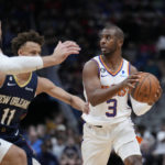 
              Phoenix Suns guard Chris Paul (3) looks to pass around New Orleans Pelicans guard Dyson Daniels (11) and center Jonas Valanciunas in the first half of an NBA basketball game in New Orleans, Sunday, Dec. 11, 2022. (AP Photo/Gerald Herbert)
            