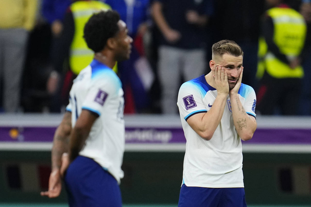 England's Luke Shaw, right, and Bukayo Saka react following the World Cup quarterfinal soccer match...
