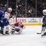 
              Vancouver Canucks' Jack Studnicka, front right, scores against Montreal Canadiens goalie Sam Montembeault (35) during the third period of an NHL hockey game in Vancouver, British Columbia, Monday, Dec. 5, 2022. (Darryl Dyck/The Canadian Press via AP)
            