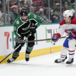
              Dallas Stars center Tyler Seguin (91) attempts to pass the puck to the front of the net as Montreal Canadiens' Johnathan Kovacevic (26) defends in the first period of an NHL hockey game, Friday, Dec. 23, 2022, in Dallas. (AP Photo/Tony Gutierrez)
            