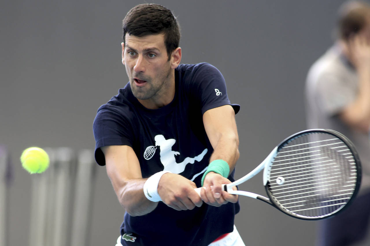 Serbia's Novak Djokovic makes a backhand return during a practice session ahead of the Adelaide Int...