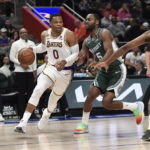 
              Los Angeles Lakers guard Russell Westbrook. left, dribbles around Detroit Pistons guard Alec Burks during the first half of an NBA basketball game, Sunday, Dec. 11, 2022, in Detroit. (AP Photo/Jose Juarez)
            