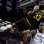 
              Wichita State forward James Rojas (33) gets past Kansas State forward David N'Guessan (3) to dunk the ball during the first half of an NCAA college basketball game Saturday, Dec. 3, 2022, in Manhattan, Kan. (AP Photo/Charlie Riedel)
            