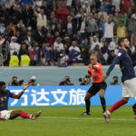 
              France's Aurelien Tchouameni, sits on the ground besides England's Jordan Henderson, background left, as referee Wilton Sampaio points to the penalty spot during the World Cup quarterfinal soccer match between England and France, at the Al Bayt Stadium in Al Khor, Qatar, Saturday, Dec. 10, 2022. (AP Photo/Frank Augstein)
            