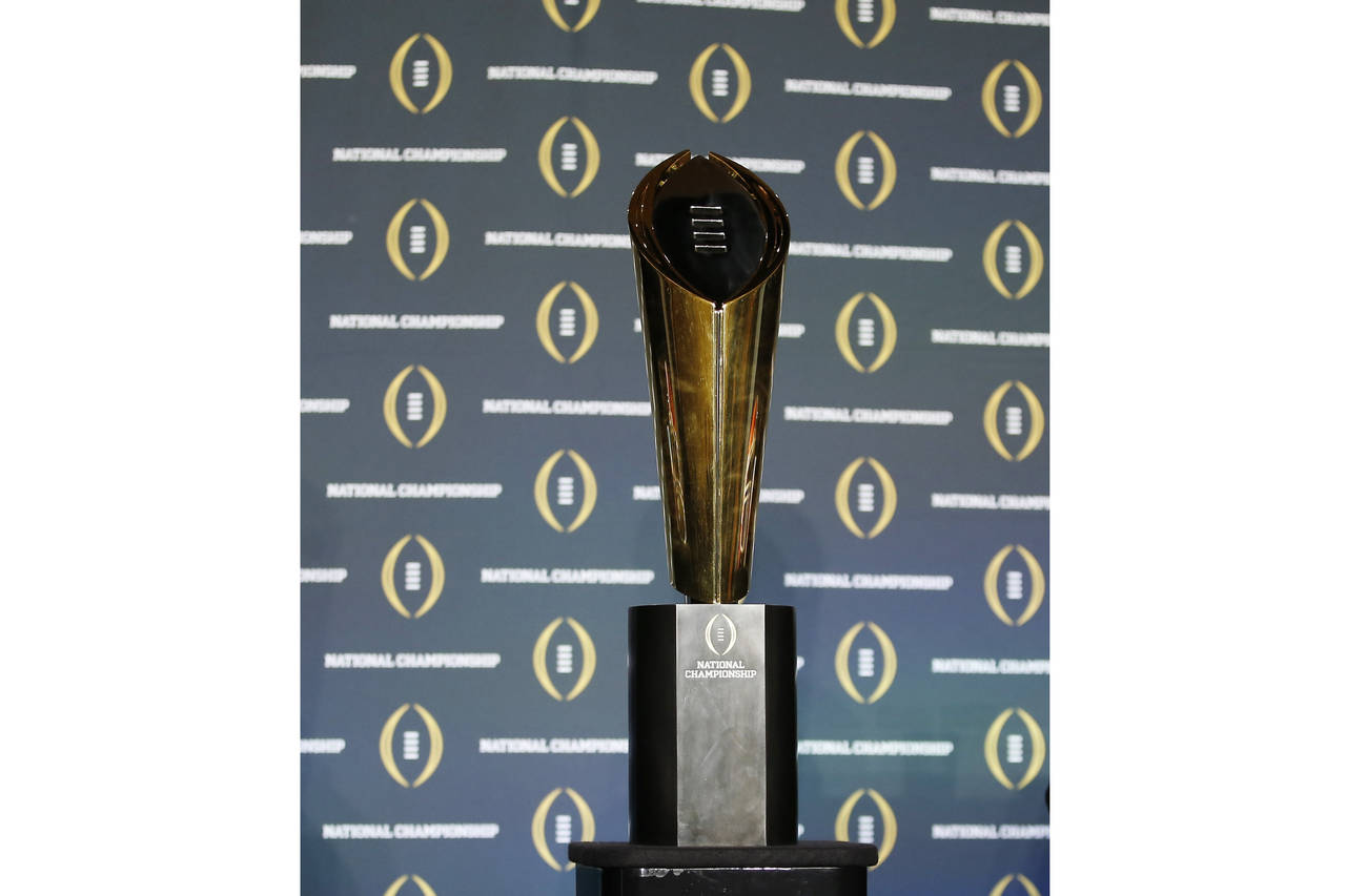 FILE - The national championship trophy is seen before a new conference for the NCAA college footba...