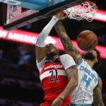 
              Washington Wizards center Daniel Gafford, left, dunks against Charlotte Hornets center Nick Richards during the first half of an NBA basketball game in Charlotte, N.C., Friday, Dec. 2, 2022. (AP Photo/Nell Redmond)
            