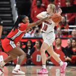 
              Ohio State forward Cotie McMahon (32) tips the ball away from Louisville guard Hailey Van Lith (10) during the first half of an NCAA college basketball game in Louisville, Ky., Wednesday, Nov. 30, 2022. Ohio State won 96-77. (AP Photo/Timothy D. Easley)
            