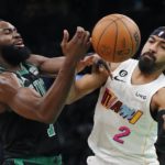 
              Boston Celtics' Jaylen Brown loses control of the ball next to Miami Heat's Gabe Vincent (2) during the first half of an NBA basketball game Friday, Dec. 2, 2022, in Boston. (AP Photo/Michael Dwyer)
            