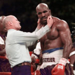 
              FILE - Evander Holyfield has his right ear checked by referee Mills Lane after he was bit on the ear by Mike Tyson during the third round of their WBA heavyweight boxing match June 28, 1997, in Las Vegas. Lane, the Hall of Fame boxing referee who was the third man in the ring when Tyson bit Holyfield’s ear, died Tuesday, Dec. 6, 2022. He was 85. Lane had suffered a stroke in 2002 and son Tommy said his father had taken a significant turn for the worse recently before entering hospice care Friday. (AP Photo/Mark J. Terrill, File)
            