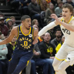 
              Indiana Pacers guard Tyrese Haliburton (0) drives to the basket as Utah Jazz's Lauri Markkanen (23) defends during the first half of an NBA basketball game Friday, Dec. 2, 2022, in Salt Lake City. (AP Photo/Rick Bowmer)
            