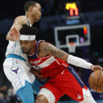 
              Washington Wizards guard Jordan Goodwin, right, drives against Charlotte Hornets guard Bryce McGowens during the first half of an NBA basketball game in Charlotte, N.C., Friday, Dec. 2, 2022. (AP Photo/Nell Redmond)
            