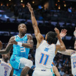 
              Charlotte Hornets guard Terry Rozier (3) looks to pass the ball around Oklahoma City Thunder guard Isaiah Joe (11) and center Mike Muscala (33) during the first half of an NBA basketball game Thursday, Dec. 29, 2022, in Charlotte, N.C. (AP Photo/Rusty Jones)
            