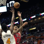 
              Chicago Bulls forward DeMar DeRozan (11) goes to the basket as Miami Heat guard Victor Oladipo (4) defends during the first half of an NBA basketball game, Tuesday, Dec. 20, 2022, in Miami. (AP Photo/Lynne Sladky)
            