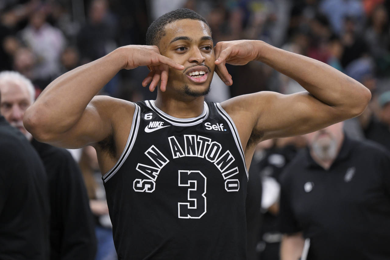 San Antonio Spurs' Keldon Johnson walks off the court after an NBA basketball game against the Clev...