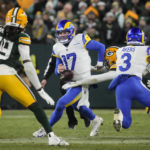 
              Los angles Rams quarterback Baker Mayfield (17) fumbles as he's hit by Green Bay Packers linebacker Quay Walker (7) in the first half of an NFL football game in Green Bay, Wis. Monday, Dec. 19, 2022. Rams recovered the ball. (AP Photo/Morry Gash)
            