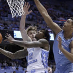 
              North Carolina guard Caleb Love (2) drives in against Citadel forwards Stephen Clark (1) and forward Jackson Price (0) during the first half of an NCAA college basketball game Tuesday, Dec. 13, 2022, in Chapel Hill, N.C. (AP Photo/Chris Seward)
            