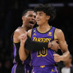
              Los Angeles Lakers guard Russell Westbrook, left, celebrates with guard Max Christie (10) after Christie shot a 3-pointer during the second half of an NBA basketball game against the Denver Nuggets in Los Angeles, Friday, Dec. 16, 2022. (AP Photo/Ashley Landis)
            