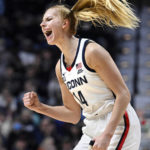 
              Connecticut's Dorka Juhasz (14) celebrates her 3-point basket during the first half of an NCAA college basketball game against Florida State, Sunday, Dec. 18, 2022, in Uncasville, Conn. (AP Photo/Jessica Hill)
            